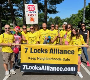 7 Locks Alliance members in member shirts and banner for parade